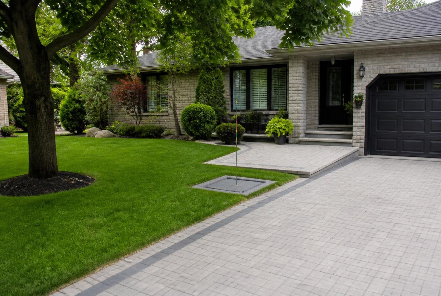 Vancouver-style residential garden and driveway above a sewer connection